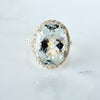 Oval Aquamarine diamond halo ring in yellow gold