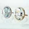 Oval Aquamarine diamond halo ring in white gold shown with an oval aquamarine in yellow gold
